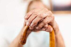 Elderly woman with a walking stick